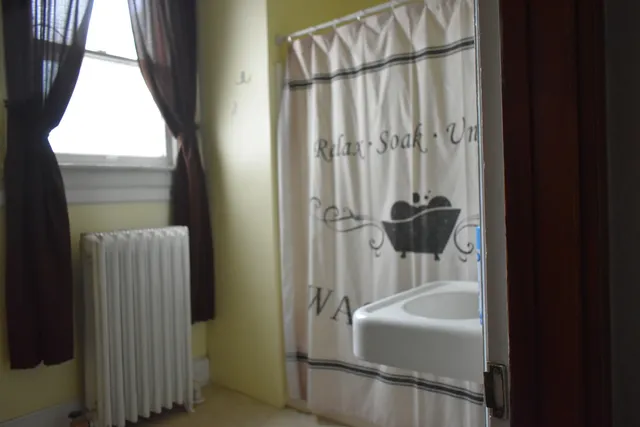 a bathroom with a toilet a sink and shower