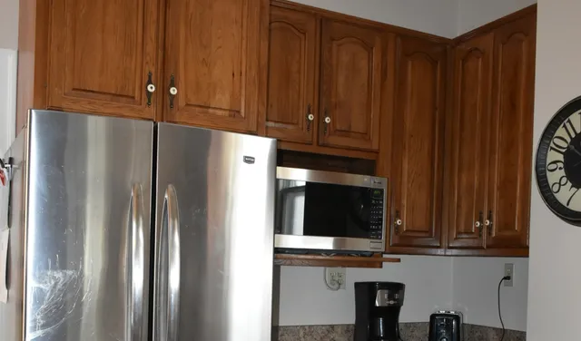 a kitchen with stainless steel appliances a refrigerator and cabinets