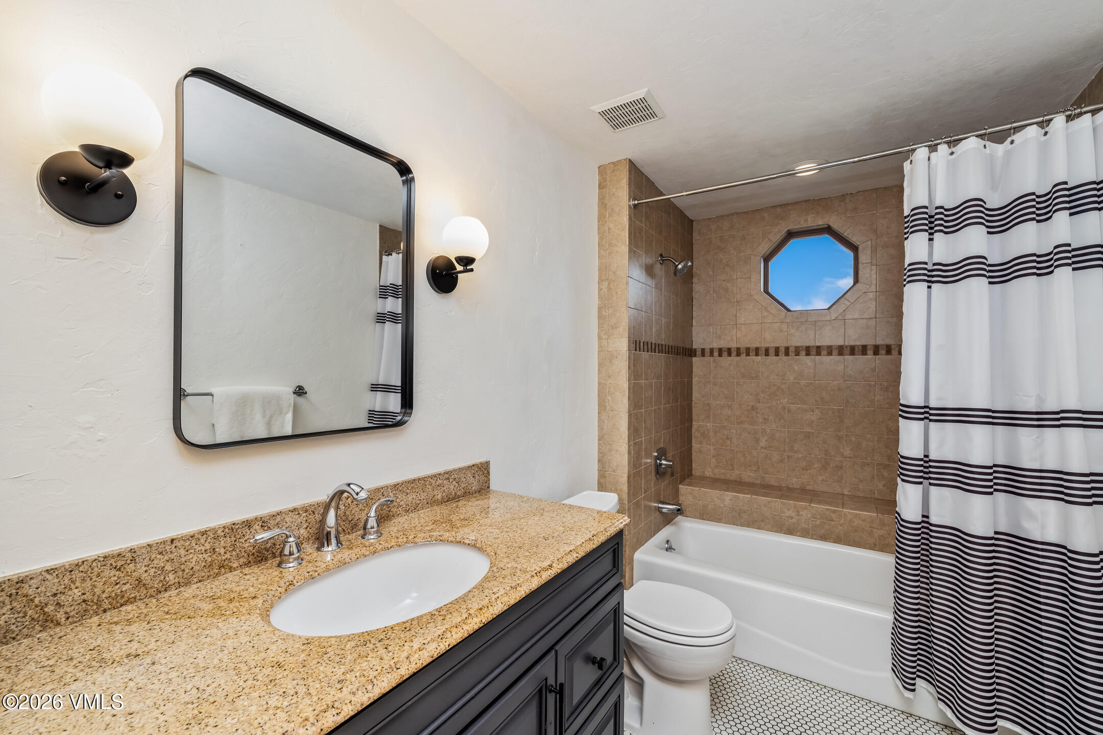 321 Meile Lane Edwards, CO 81632 - Photo 19 of 44 a bathroom with a granite countertop sink toilet mirror and shower