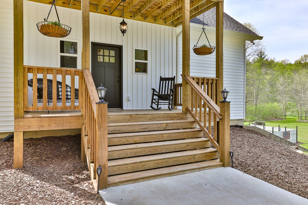 2001 Big Creek Road Ellijay, GA 30536 - Photo 17 of 73 a view of a house with a small yard and a wooden fence