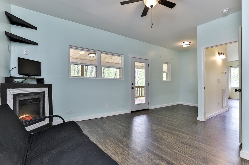 2001 Big Creek Road Ellijay, GA 30536 - Photo 30 of 73 a view of an empty room with wooden floor fireplace and a window