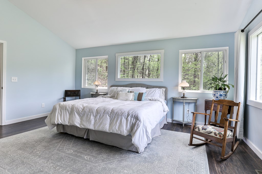 2001 Big Creek Road Ellijay, GA 30536 - Photo 33 of 73 a bedroom with a bed a chair and a large window