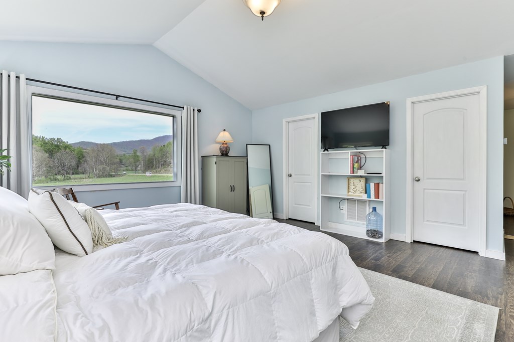 2001 Big Creek Road Ellijay, GA 30536 - Photo 34 of 73 a bedroom with a bed and a flat screen tv