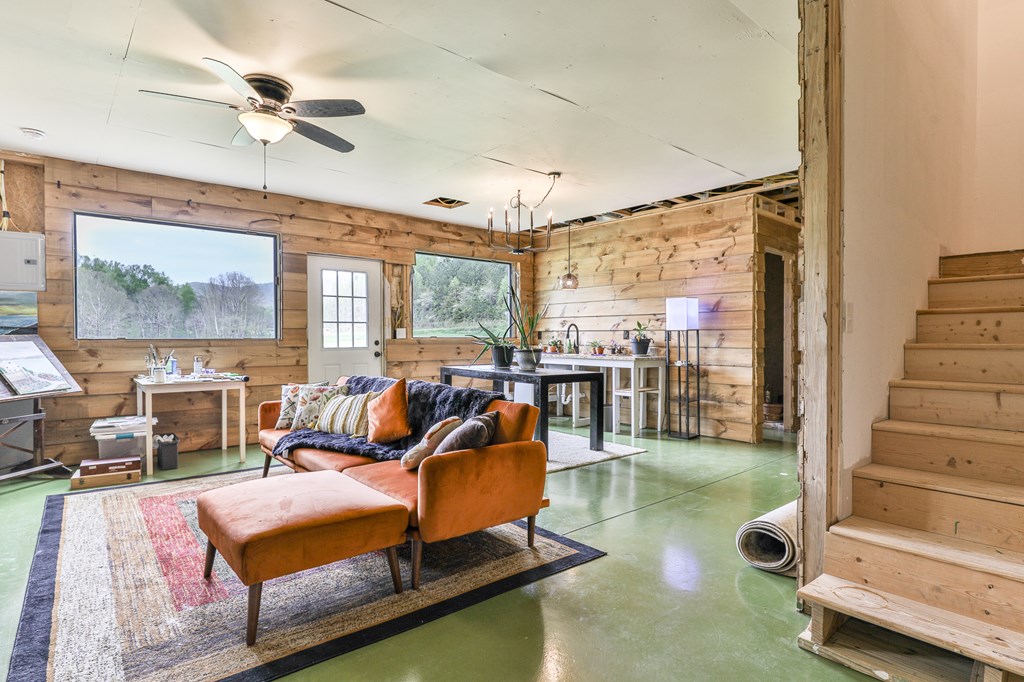 2001 Big Creek Road Ellijay, GA 30536 - Photo 45 of 73 a living room with furniture gym equipment and a large window