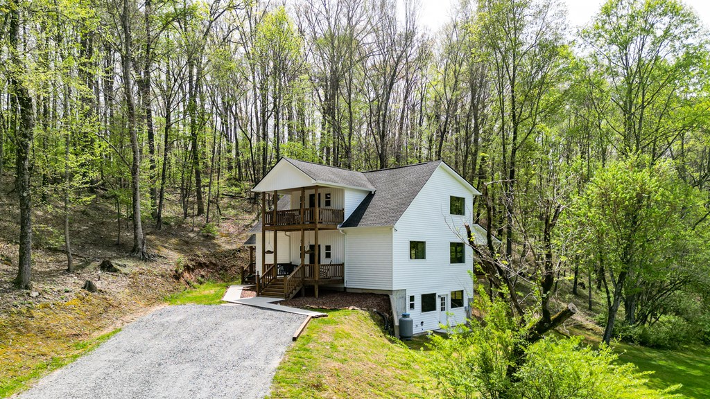 2001 Big Creek Road Ellijay, GA 30536 - Photo 70 of 73 a front view of a house with a yard table and chairs