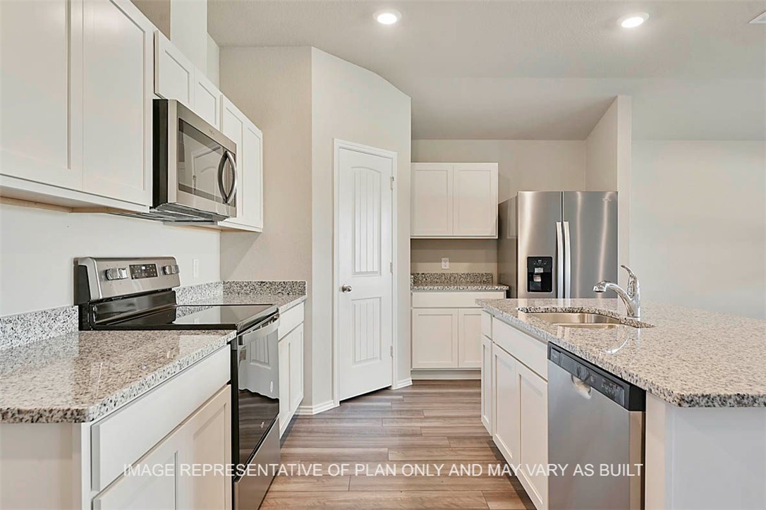 5425 Bear Run Bryan, TX 77807 - Photo 3 of 16 a kitchen with stainless steel appliances granite countertop a sink stove and refrigerator