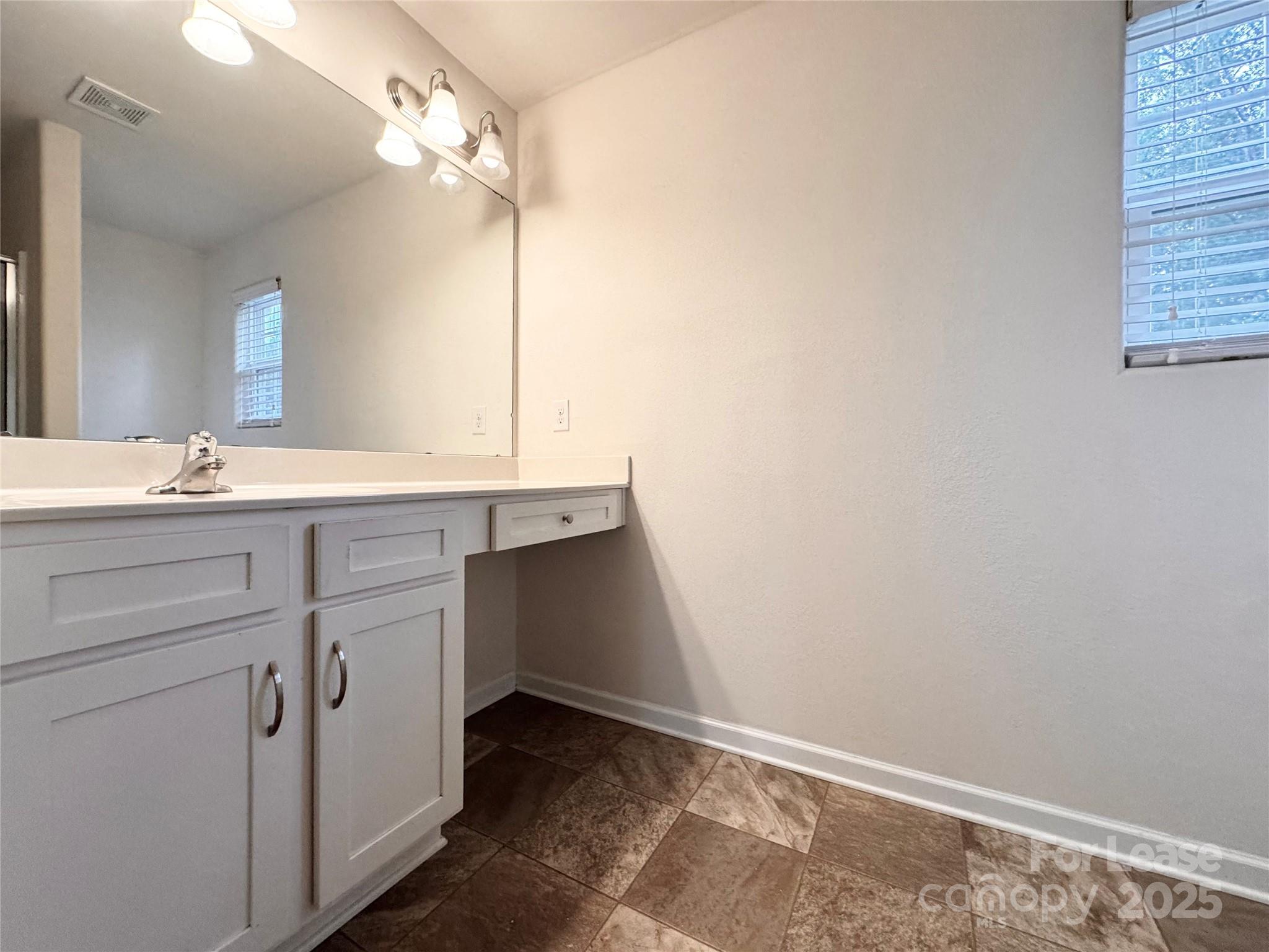 6717 Ware Road Charlotte, NC 28212 - Photo 12 of 22 a bathroom with a sink and a mirror