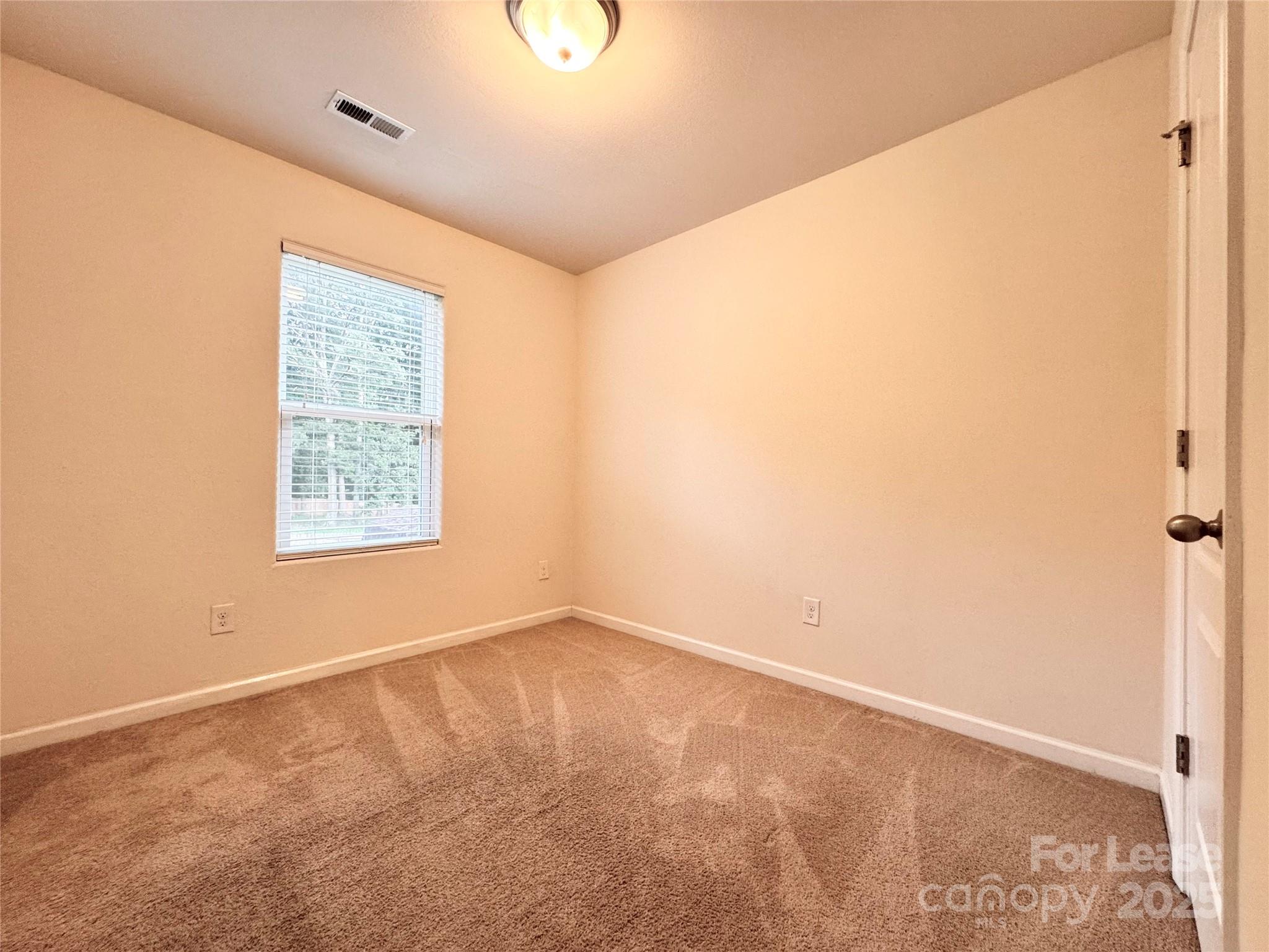 6717 Ware Road Charlotte, NC 28212 - Photo 15 of 22 an empty room with a window