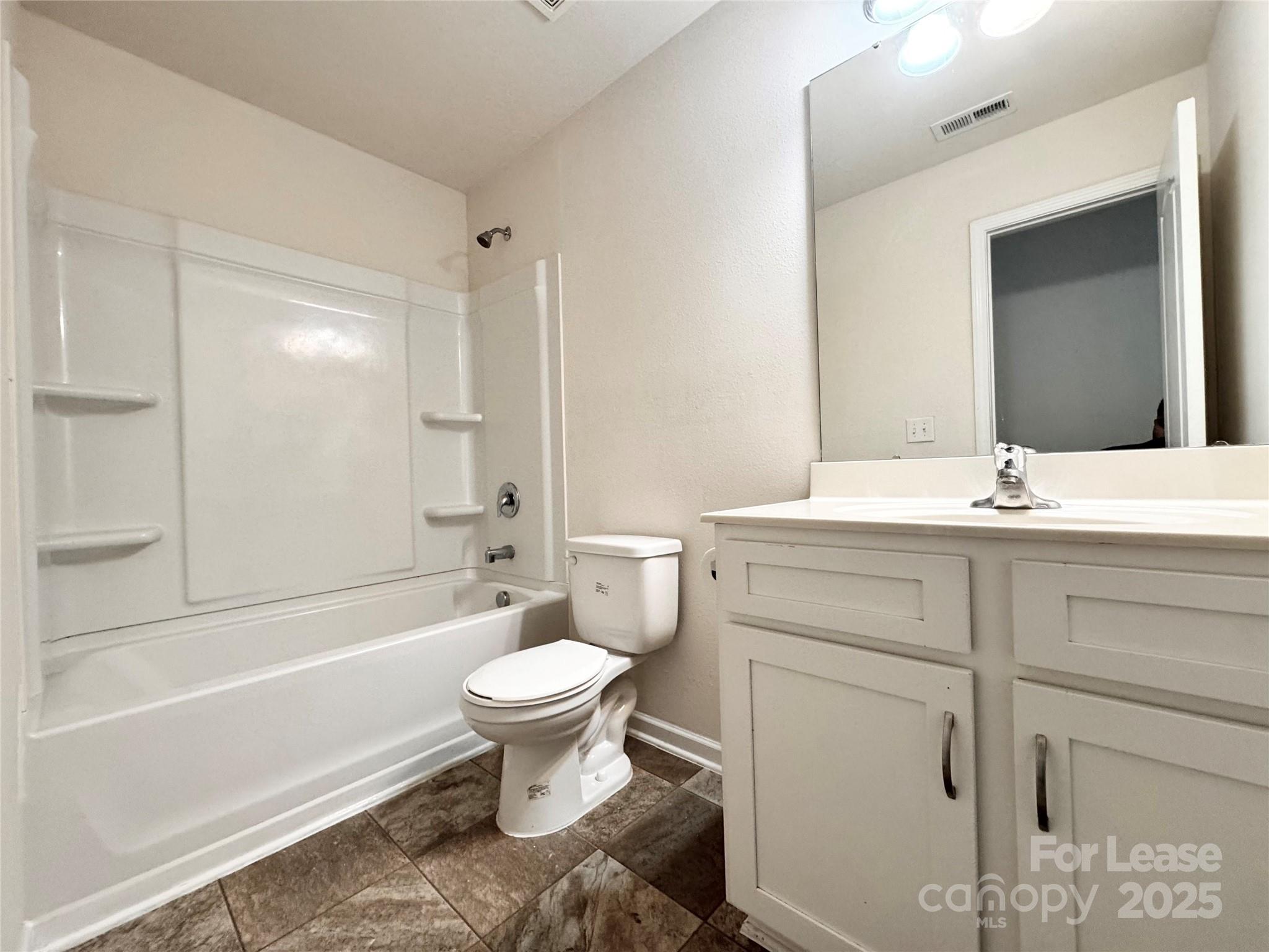 6717 Ware Road Charlotte, NC 28212 - Photo 16 of 22 a bathroom with a sink toilet a mirror and shower