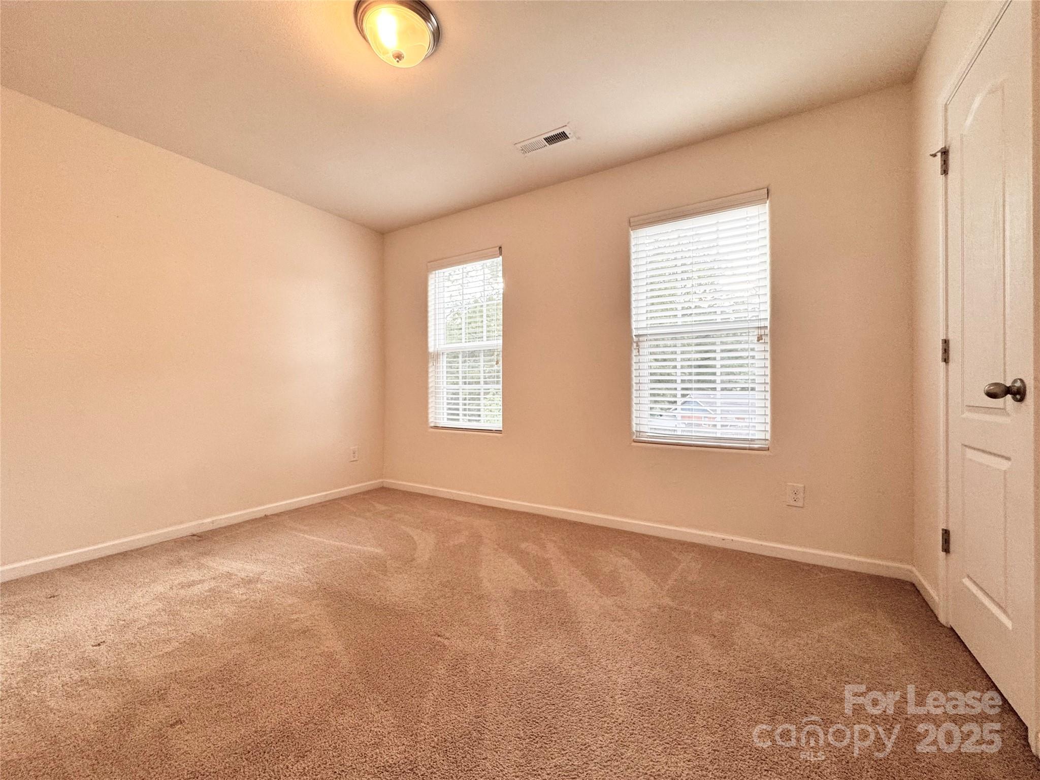 6717 Ware Road Charlotte, NC 28212 - Photo 17 of 22 an empty room with windows and closet