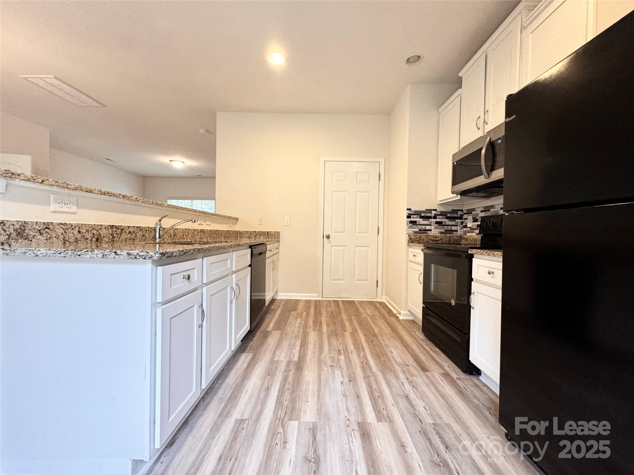 6717 Ware Road Charlotte, NC 28212 - Photo 5 of 22 a kitchen with a sink stove and refrigerator