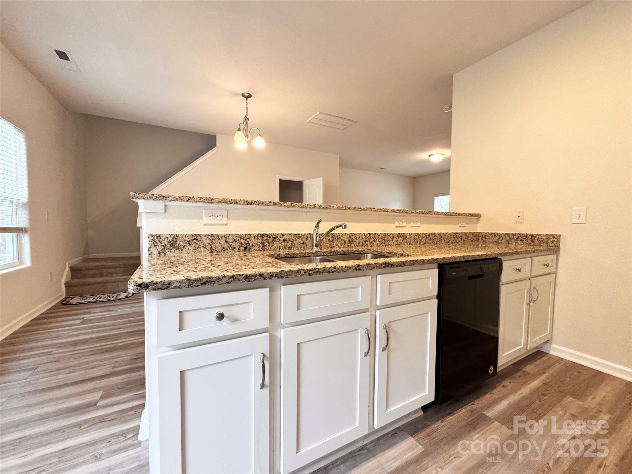 6717 Ware Road Charlotte, NC 28212 - Photo 6 of 22 a kitchen with granite countertop a sink and cabinets