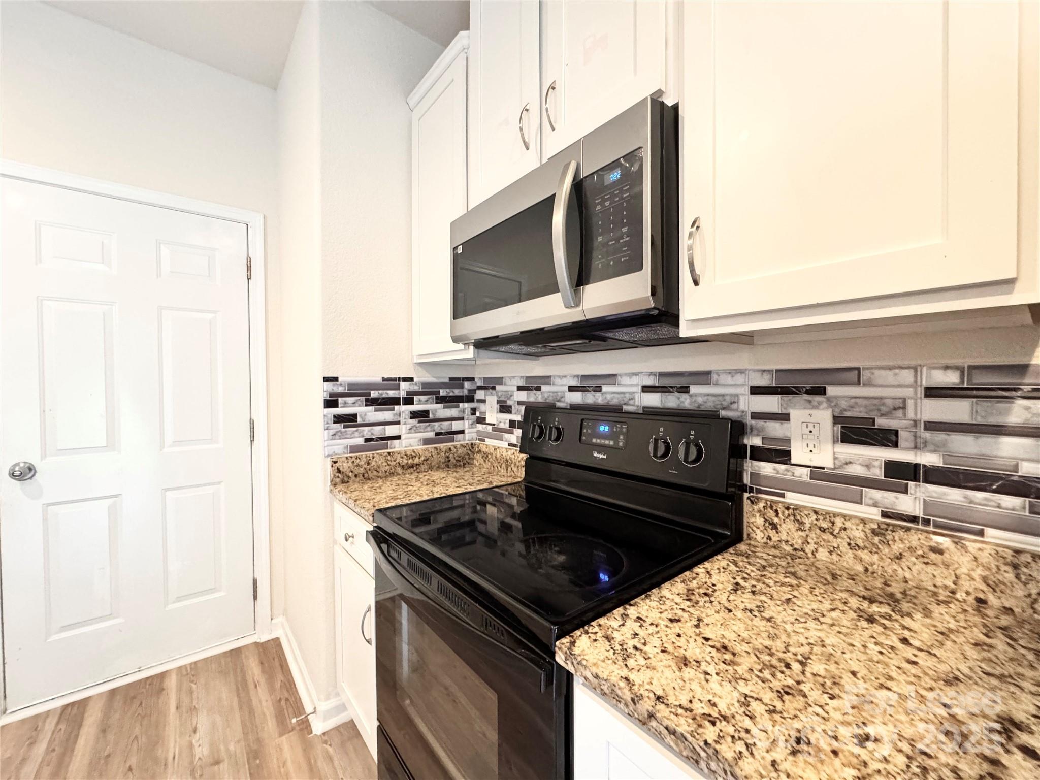 6717 Ware Road Charlotte, NC 28212 - Photo 8 of 22 a kitchen with a stove and a microwave