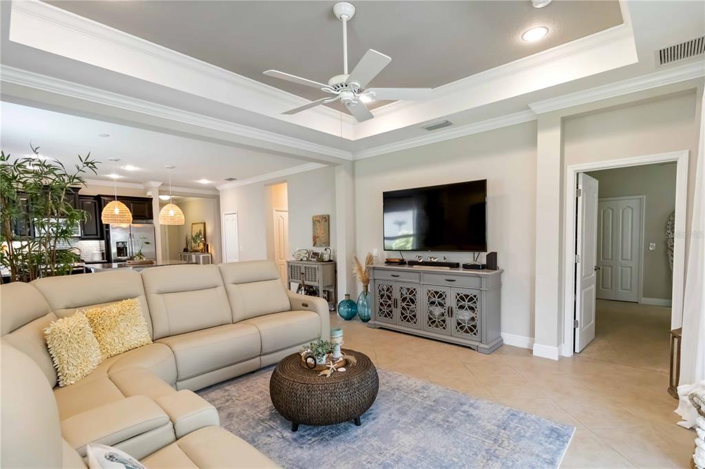 12252 Stuart Drive Venice, FL 34293 - Photo 12 of 70 a living room with furniture and a flat screen tv