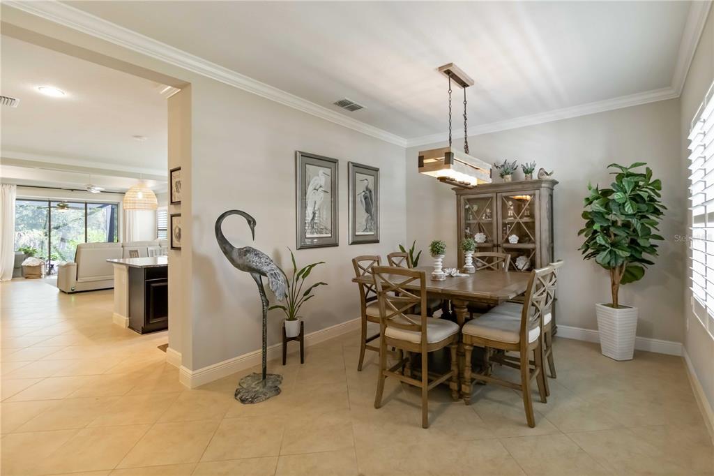 12252 Stuart Drive Venice, FL 34293 - Photo 17 of 70 a dining room with furniture and a chandelier