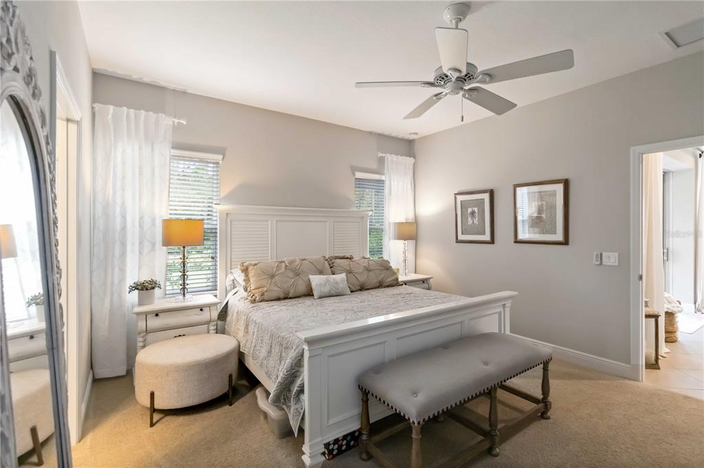 12252 Stuart Drive Venice, FL 34293 - Photo 19 of 70 a bedroom with a bed and a chandelier