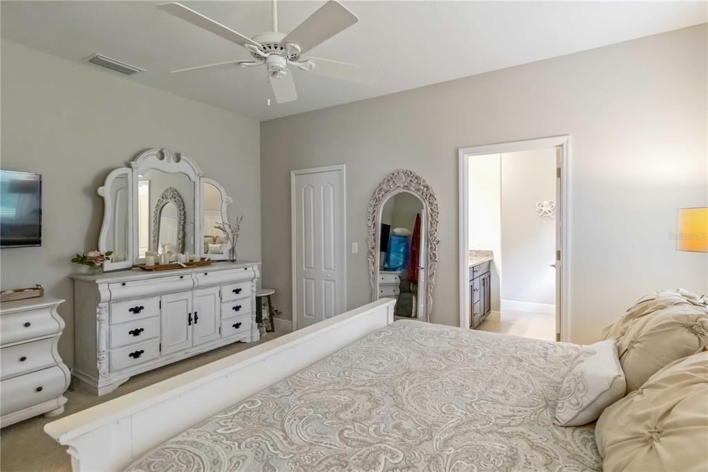 12252 Stuart Drive Venice, FL 34293 - Photo 20 of 70 a bedroom with a bed and a dresser