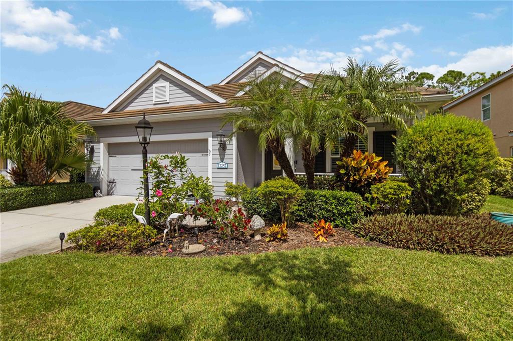 12252 Stuart Drive Venice, FL 34293 - Photo 2 of 70 a front view of a house with a yard
