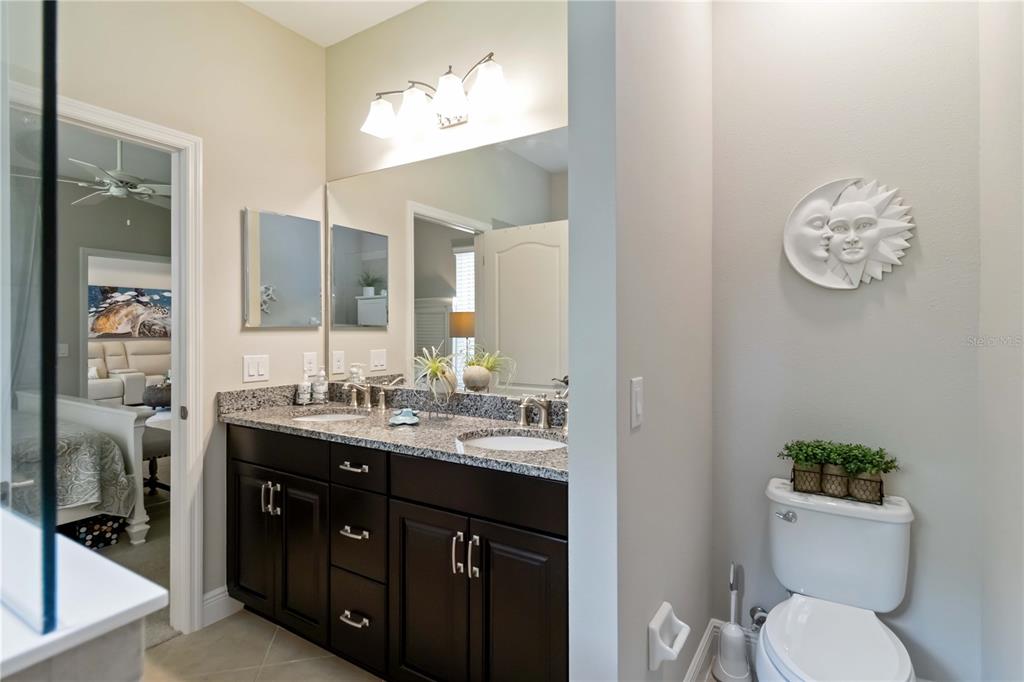 12252 Stuart Drive Venice, FL 34293 - Photo 21 of 70 a bathroom with a toilet a sink and mirror