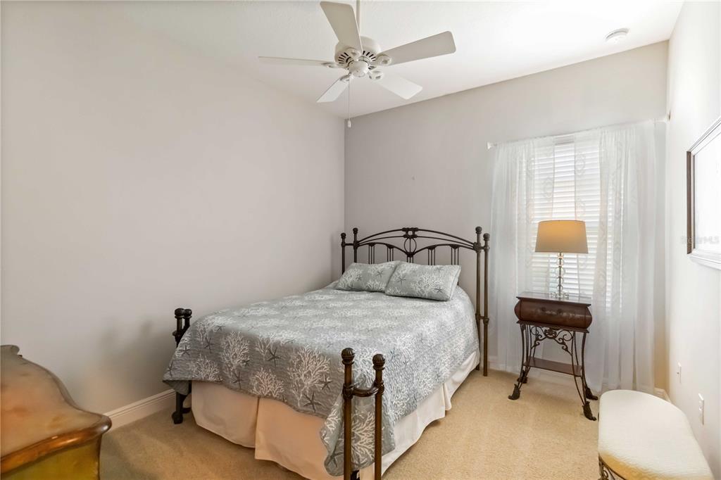 12252 Stuart Drive Venice, FL 34293 - Photo 24 of 70 a bedroom with a bed and a lamp