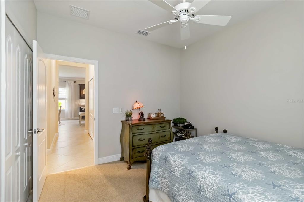 12252 Stuart Drive Venice, FL 34293 - Photo 25 of 70 a bedroom with a bed and a chandelier