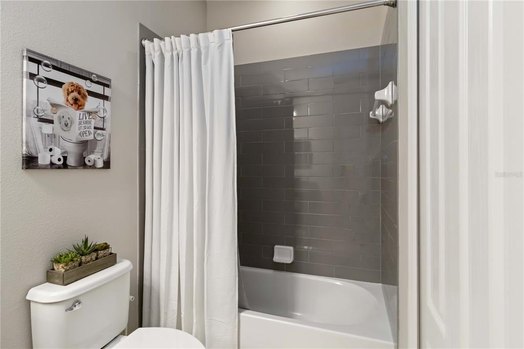 12252 Stuart Drive Venice, FL 34293 - Photo 30 of 70 a bathroom with a toilet and a shower curtain