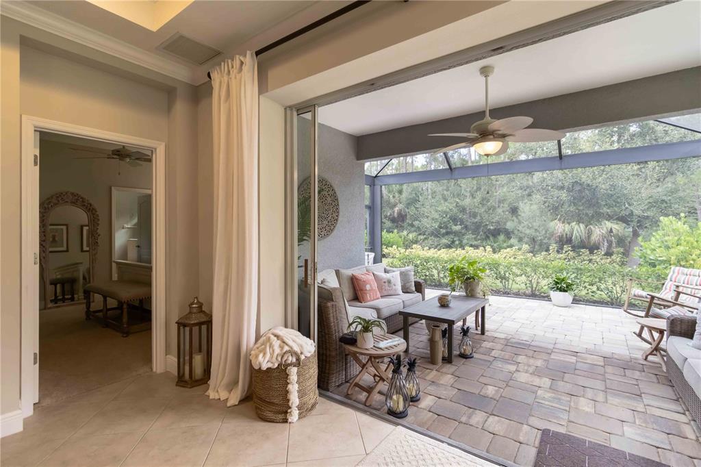 12252 Stuart Drive Venice, FL 34293 - Photo 31 of 70 a living room with patio furniture and a floor to ceiling window