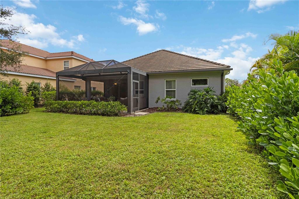 12252 Stuart Drive Venice, FL 34293 - Photo 39 of 70 a front view of a house with garden