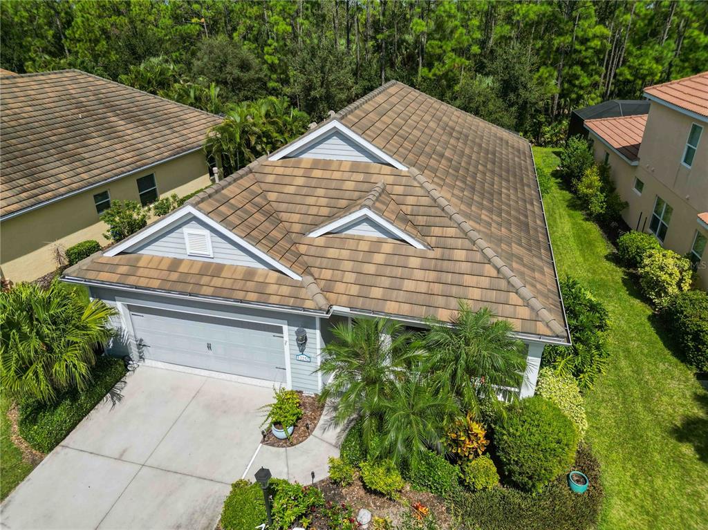 12252 Stuart Drive Venice, FL 34293 - Photo 45 of 70 a aerial view of a house with a yard and potted plants
