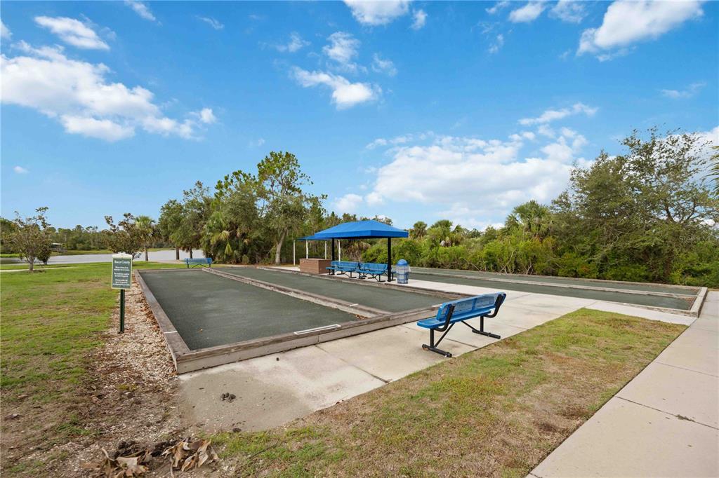 12252 Stuart Drive Venice, FL 34293 - Photo 51 of 70 a view of a swimming pool with a yard and sitting area