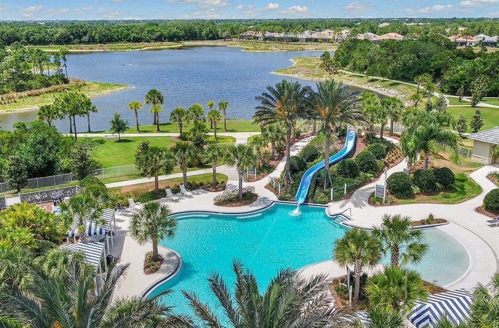 12252 Stuart Drive Venice, FL 34293 - Photo 68 of 70 a view of a lake with lawn chairs and large trees