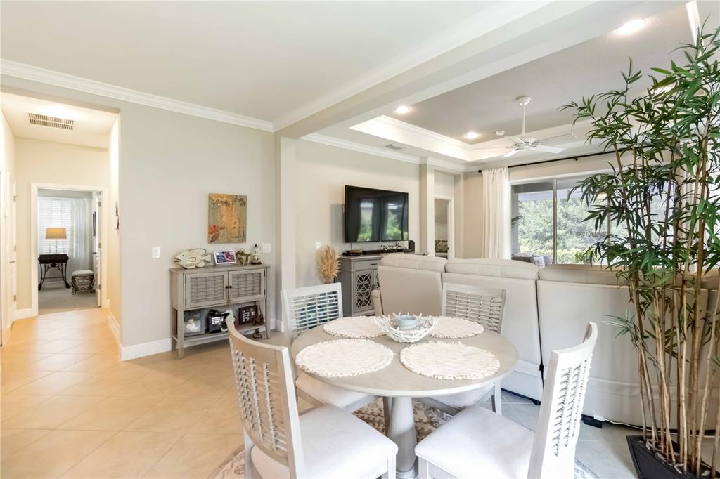 12252 Stuart Drive Venice, FL 34293 - Photo 7 of 70 a living room with furniture a dining table and a potted plant