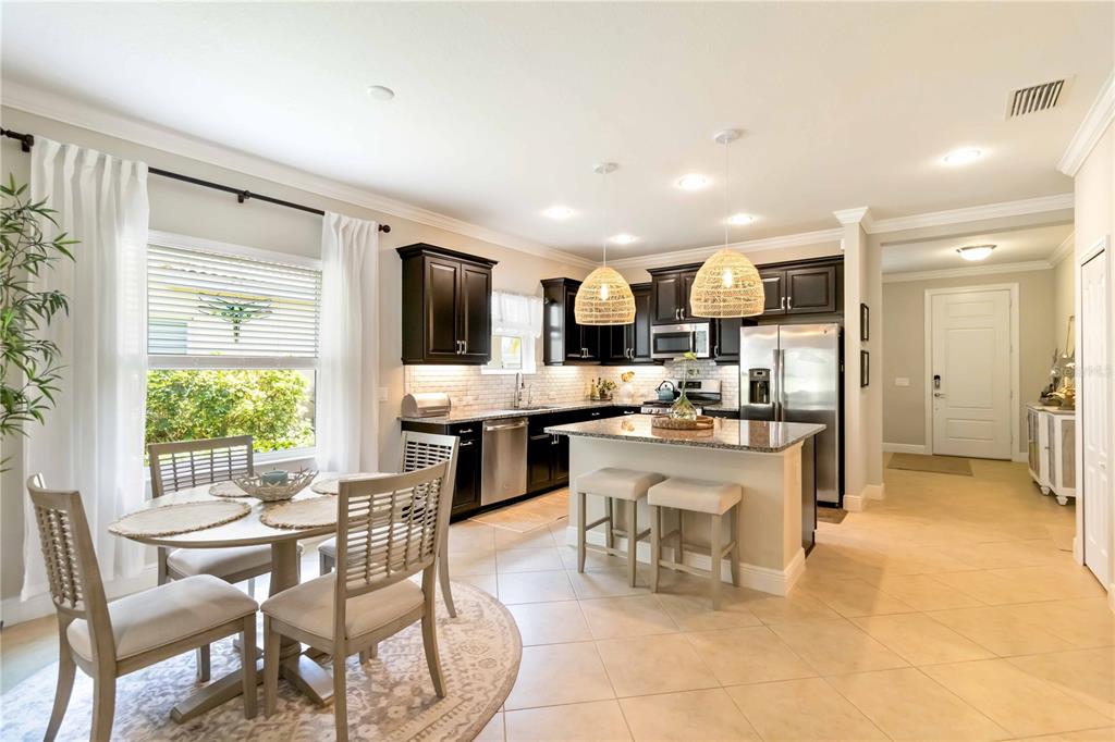 12252 Stuart Drive Venice, FL 34293 - Photo 8 of 70 a kitchen with a table and chairs in it