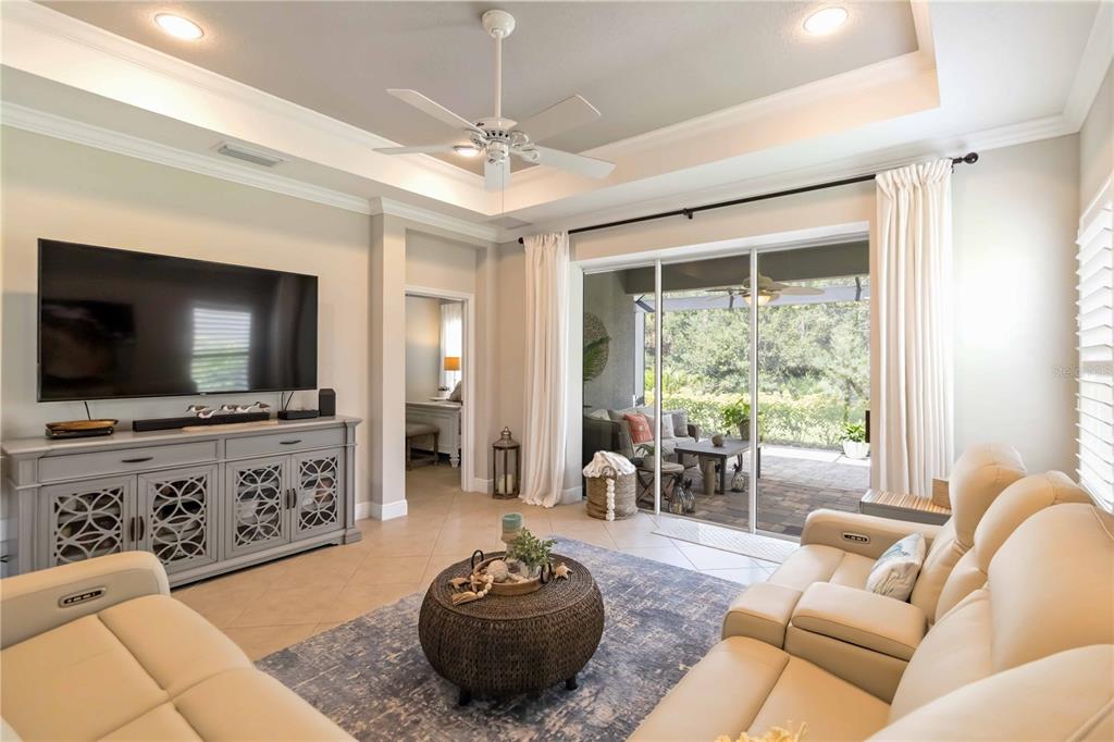 12252 Stuart Drive Venice, FL 34293 - Photo 10 of 70 a living room with furniture and a flat screen tv