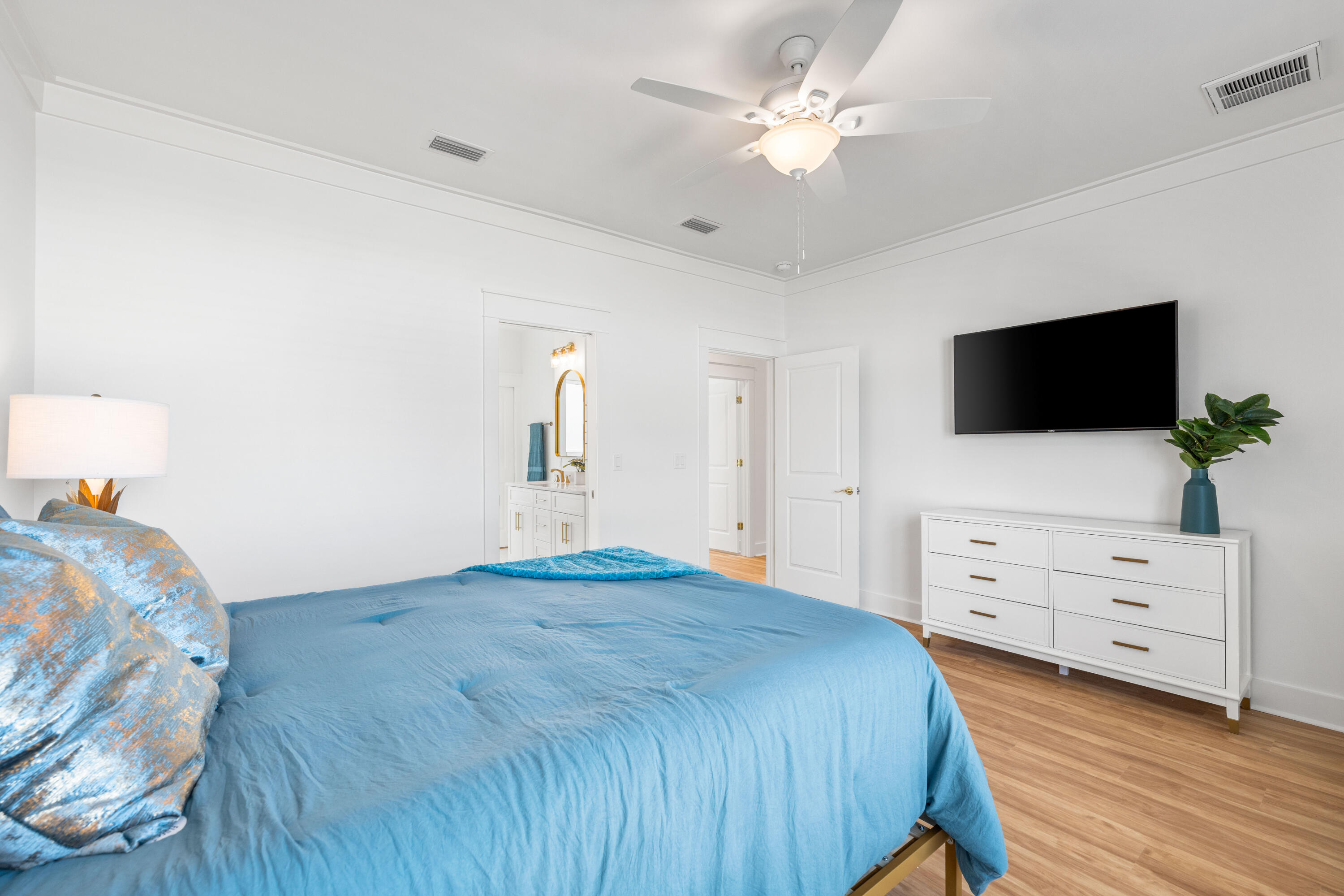 104 Fletcher Way Destin, FL 32541 - Photo 26 of 59 a bedroom with a bed and a flat tv screen on dresser