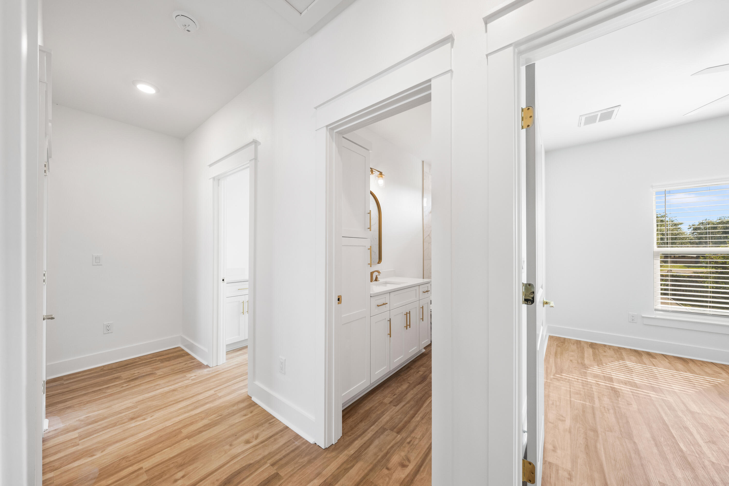 104 Fletcher Way Destin, FL 32541 - Photo 36 of 59 a view of a hallway with wooden floor and cabinet