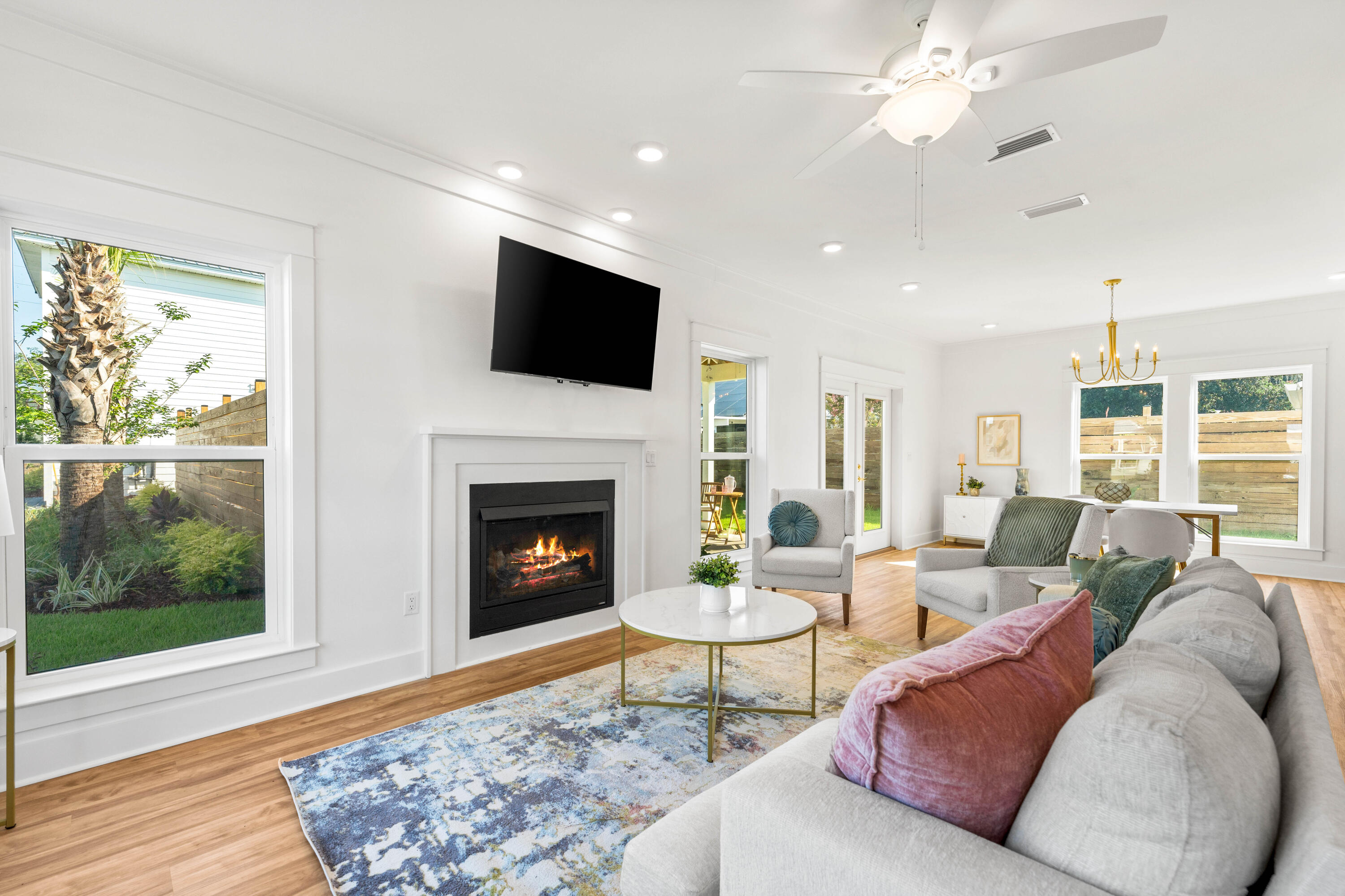 104 Fletcher Way Destin, FL 32541 - Photo 8 of 59 a living room with furniture a fireplace and a flat screen tv