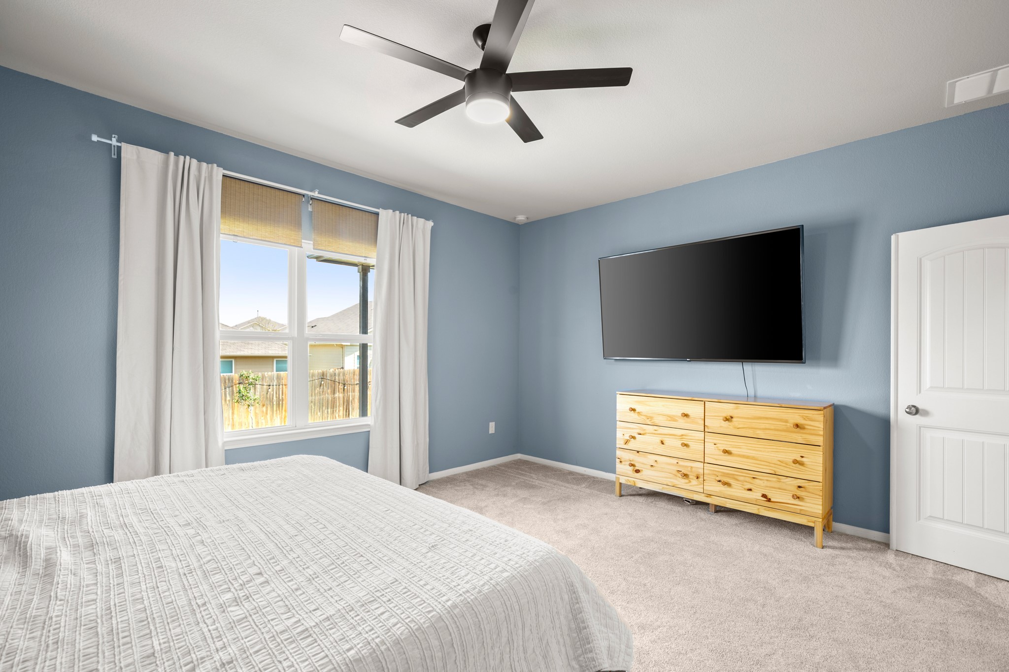 6520 Ranchito Drive Austin, TX 78744 - Photo 13 of 40 a bedroom with a bed and a flat screen tv