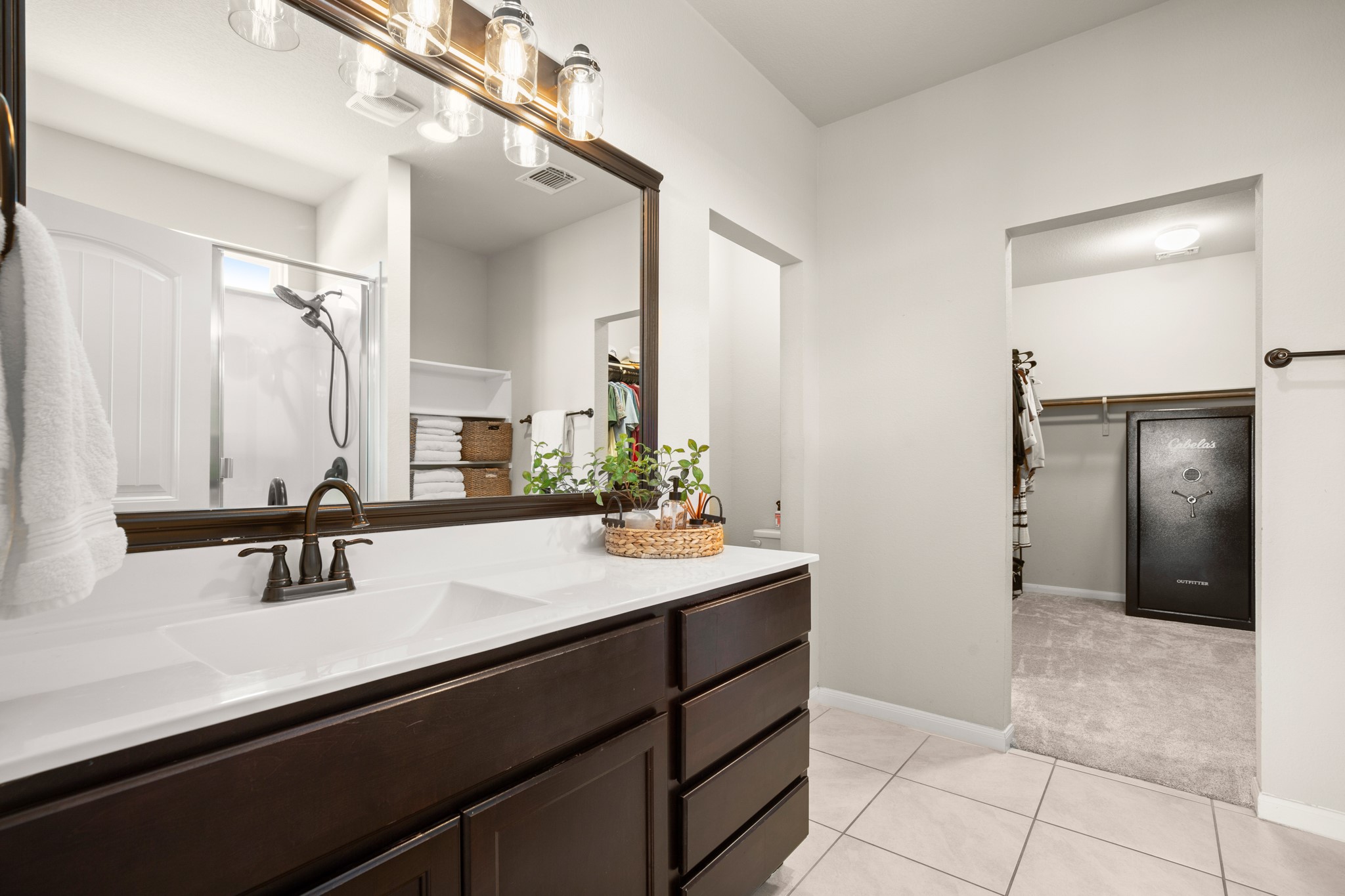 6520 Ranchito Drive Austin, TX 78744 - Photo 14 of 40 a bathroom with a sink a vanity a mirror and shower