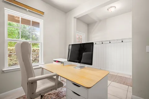a living room with furniture a window and a table