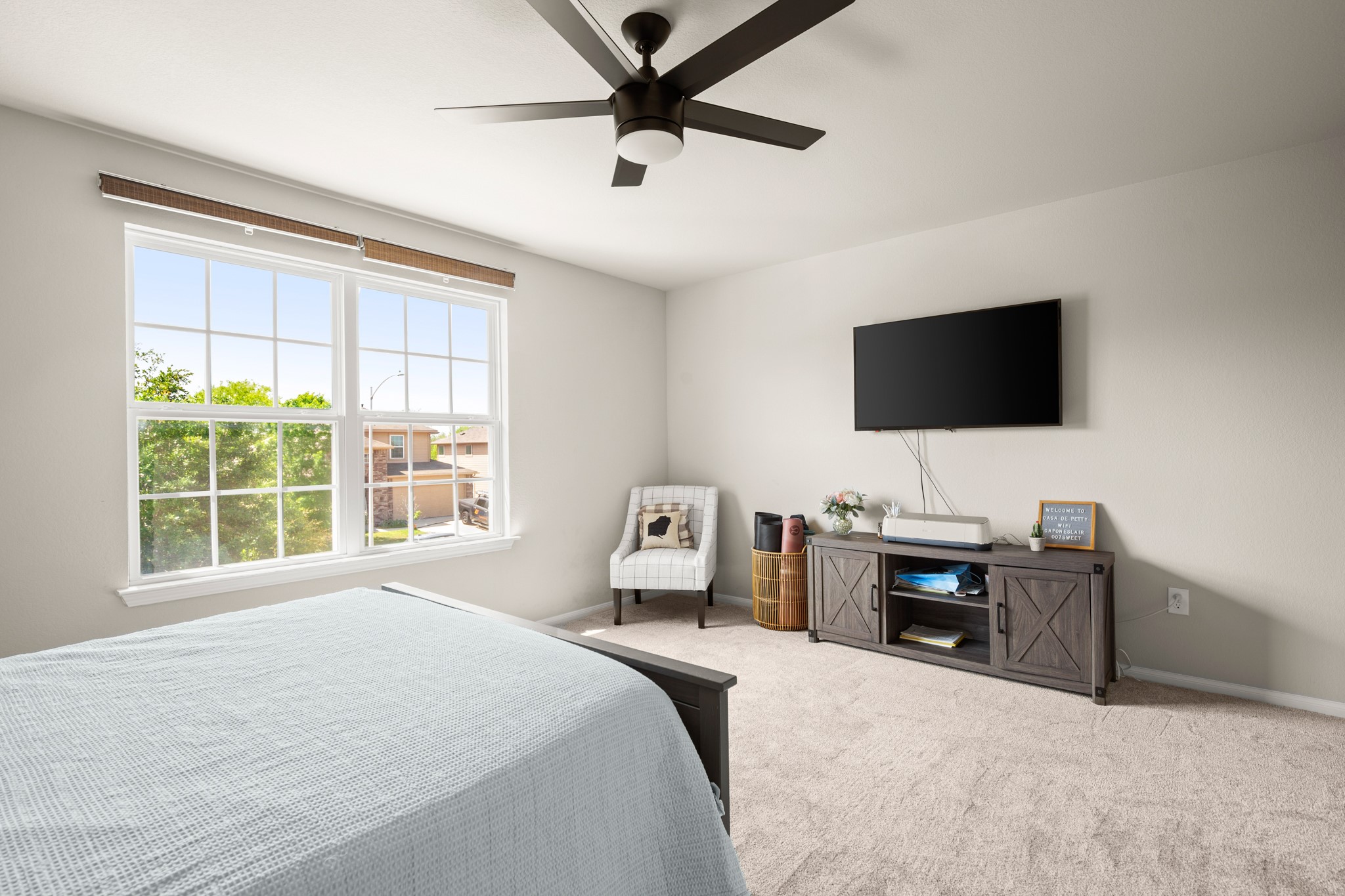 6520 Ranchito Drive Austin, TX 78744 - Photo 25 of 40 a bedroom with a bed and a flat screen tv