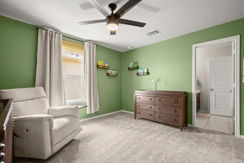 a white bed sitting in a bedroom next to a window