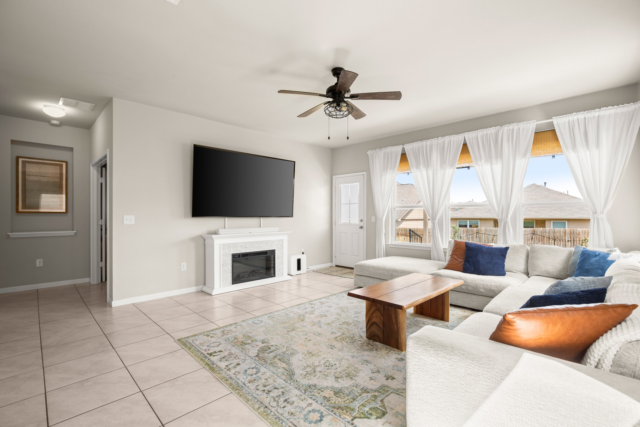 6520 Ranchito Drive Austin, TX 78744 - Photo 3 of 40 a living room with furniture a flat screen tv and a fireplace