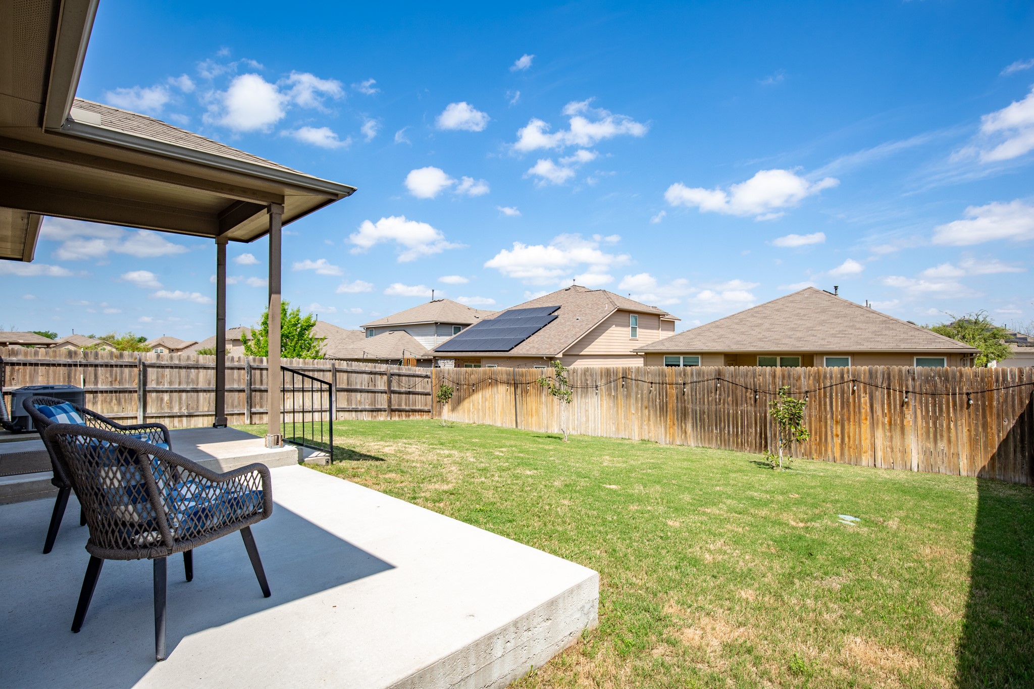 6520 Ranchito Drive Austin, TX 78744 - Photo 31 of 40 a view of a chairs and table in the patio next to a yard