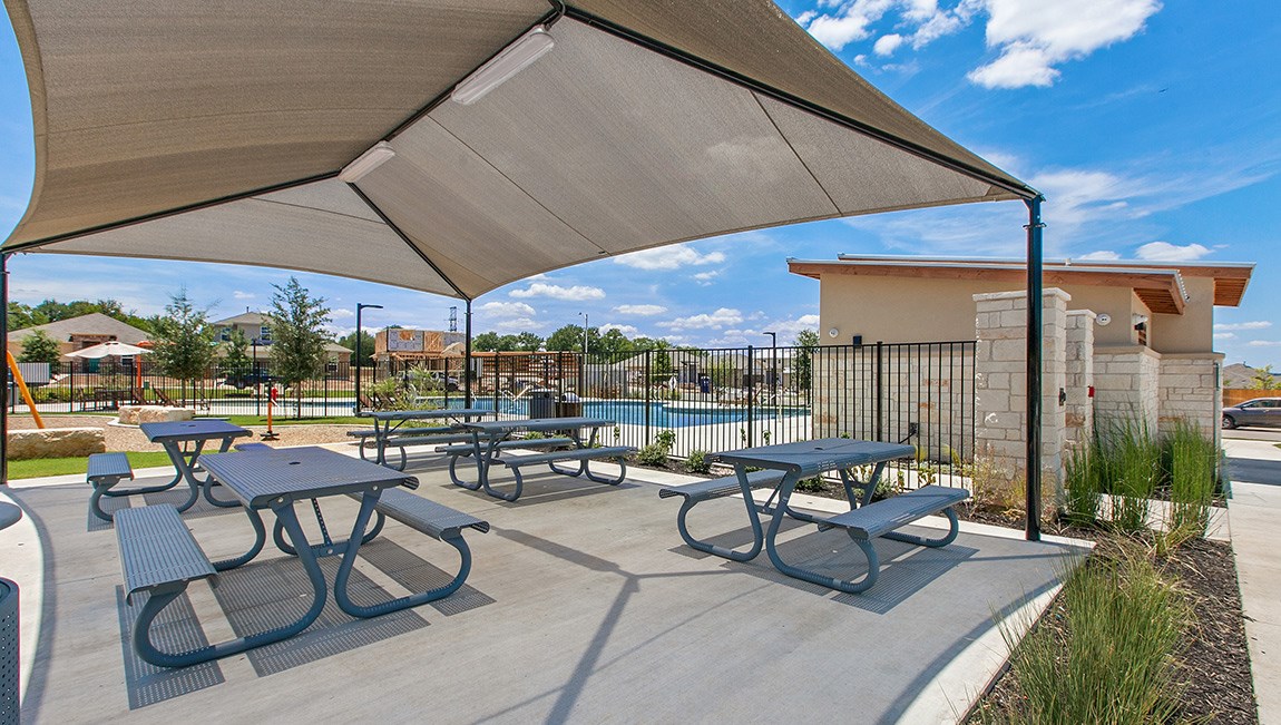6520 Ranchito Drive Austin, TX 78744 - Photo 38 of 40 a view of a patio with couches and table under an umbrella