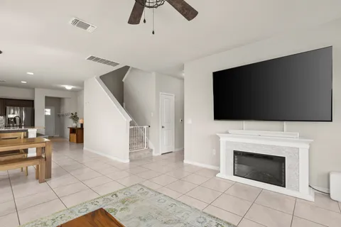 a living room with furniture a flat screen tv and a fireplace