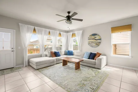 a living room with furniture and a large window