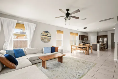 a living room with furniture and wooden floor