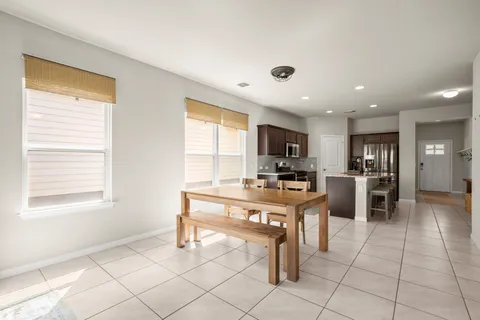 a kitchen with stainless steel appliances kitchen island granite top and refrigerator