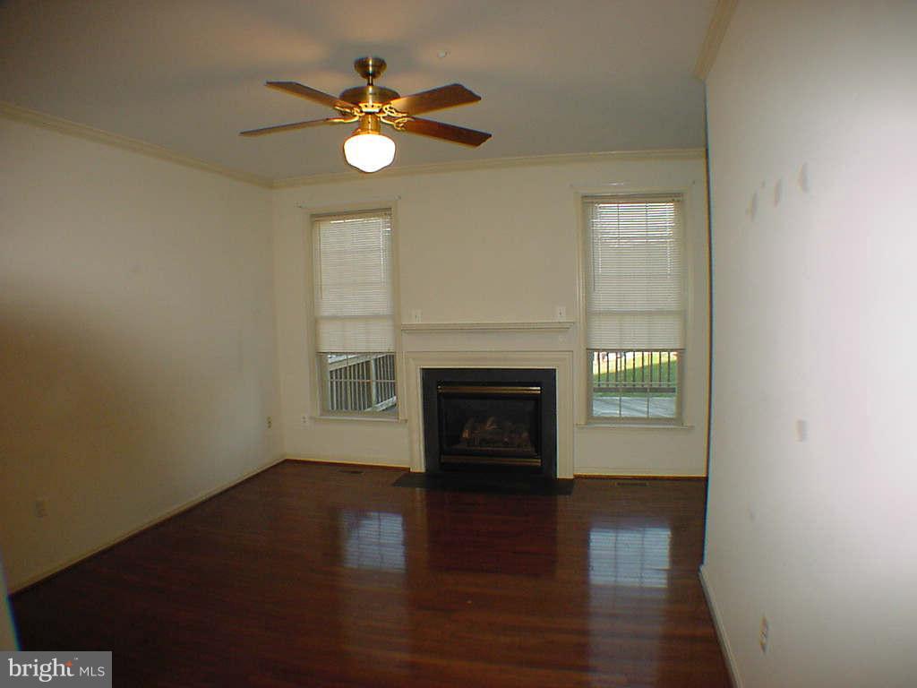 2430 Rippling Brook Road Frederick, MD 21701 - Photo 3 of 30 a view of a livingroom with a fireplace a window and wooden floor